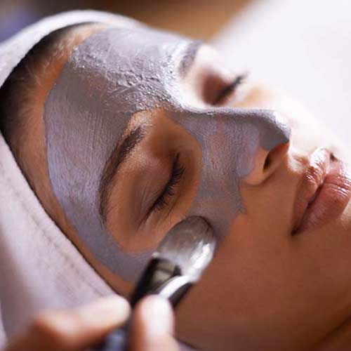 woman getting facial treatment at a spa