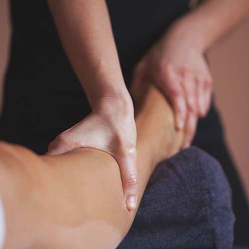 photo of registered massage therapist working on leg